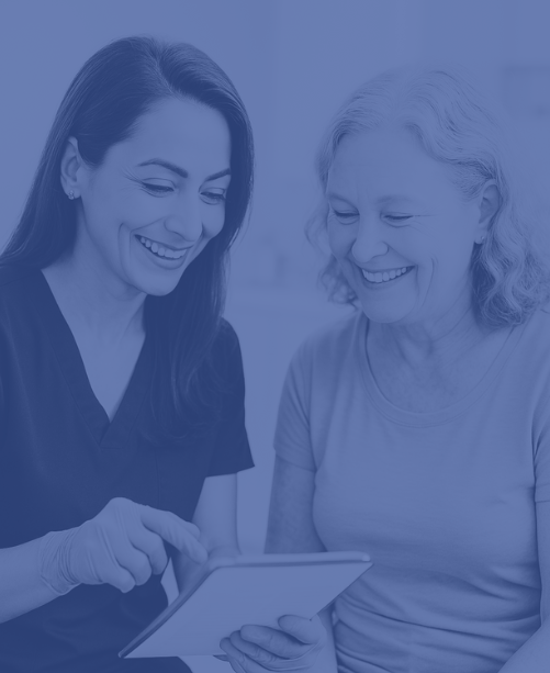 Vascular technologist in Austin reviewing screening results with happy patient in clinic