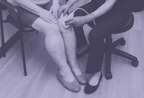 Female vascular technologist performing a leg ultrasound on a middle-aged woman with visible veins in a warm, modern clinic in Austin, TX